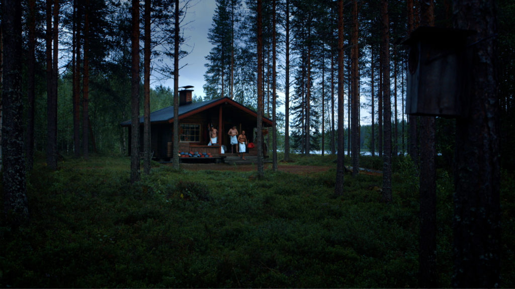 Log cabin in the woods men with towels walking out