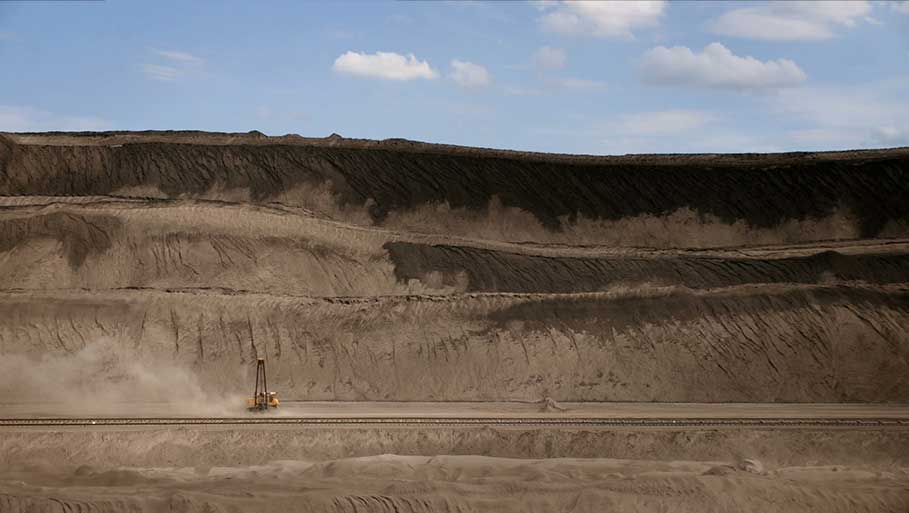 Excavator driving through dirt