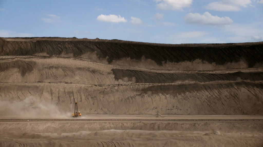 Excavator driving through dirt