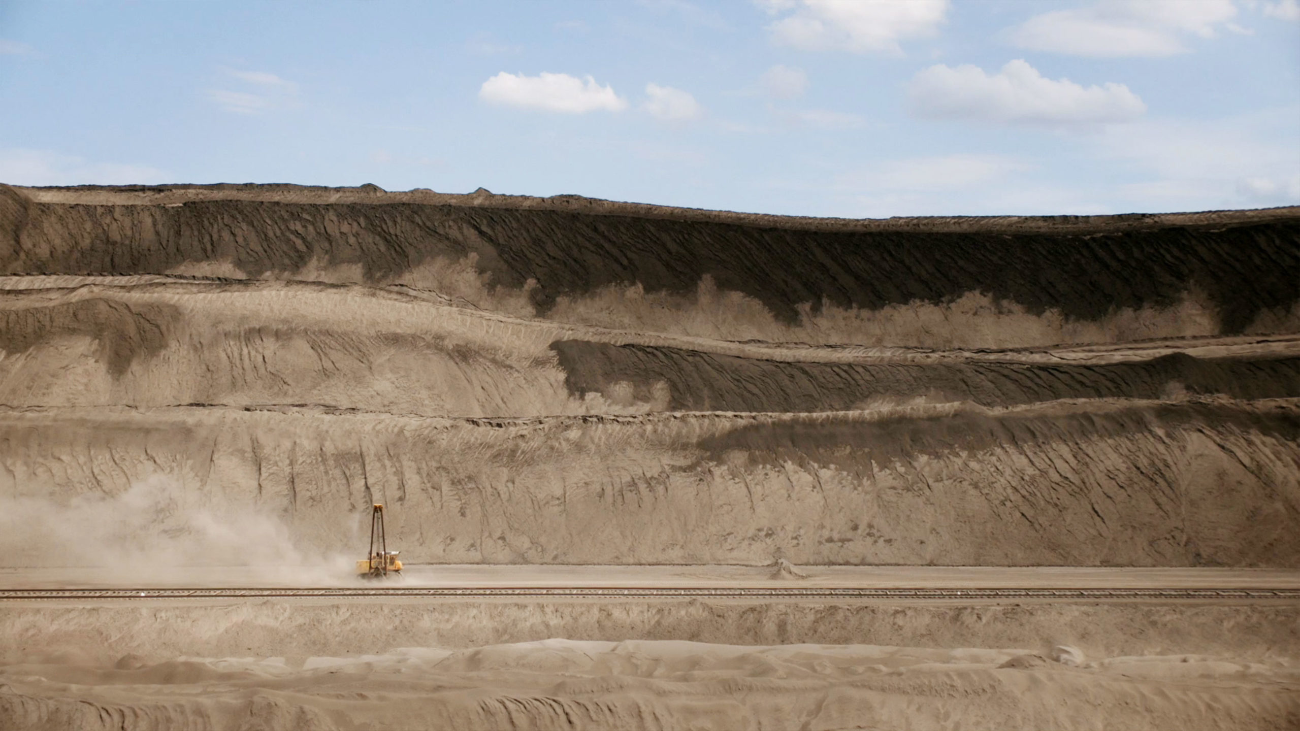 Excavator driving through dirt