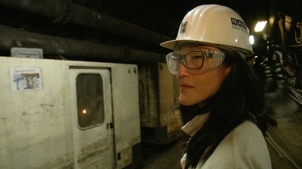 Woman with working goggles and helmet