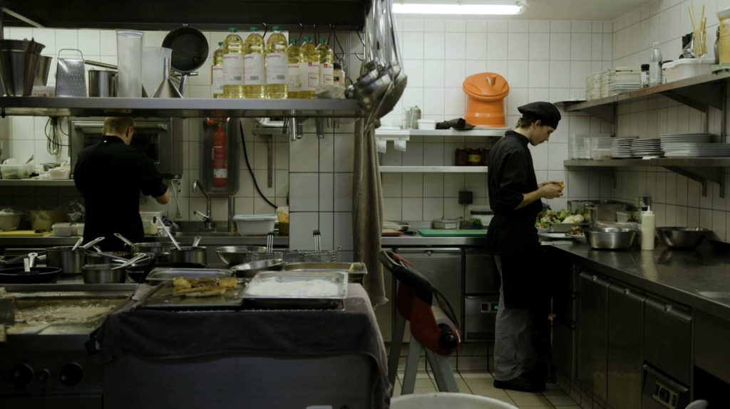 Young Man working in Restaurant Kitchen
