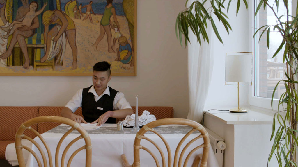 Young Man working in a Hotel Restaurant