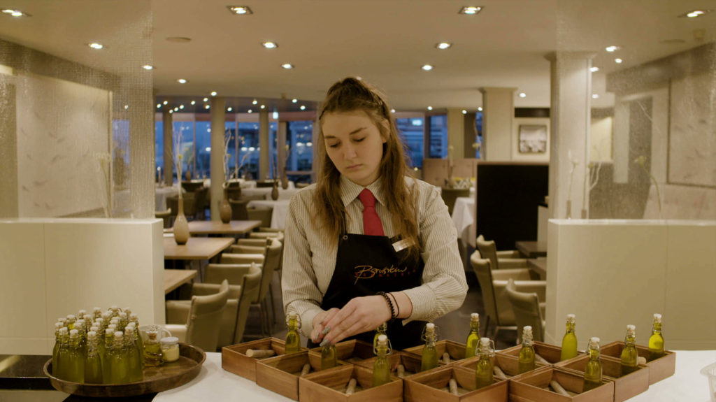 Young Woman Working in a Hotel Restaurant