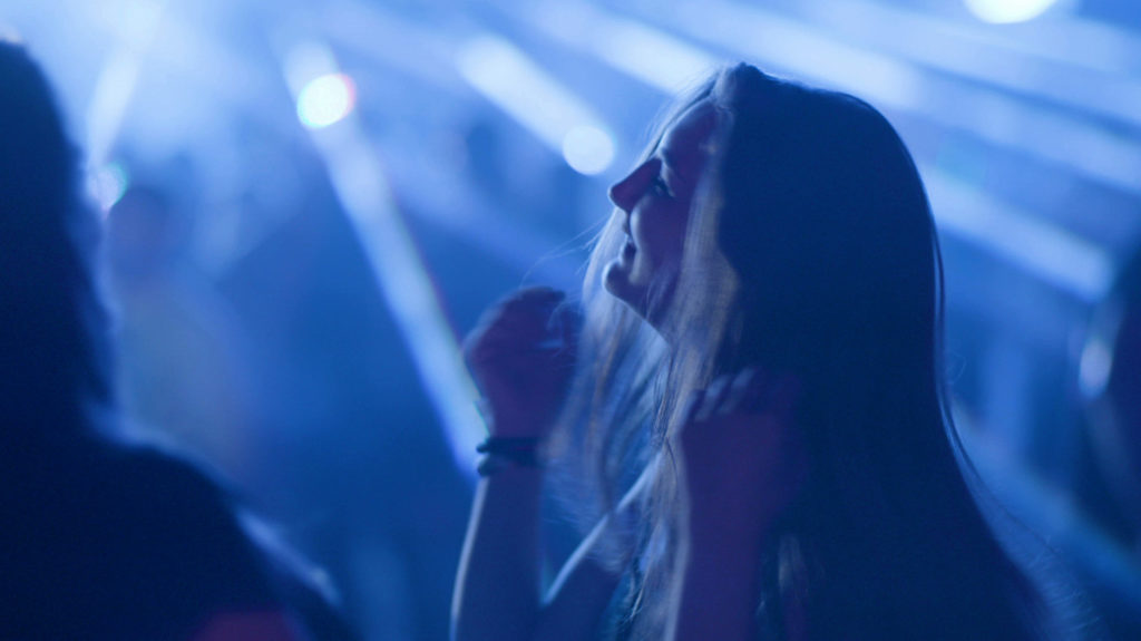 Young Woman Dancing and Laughing in a Club