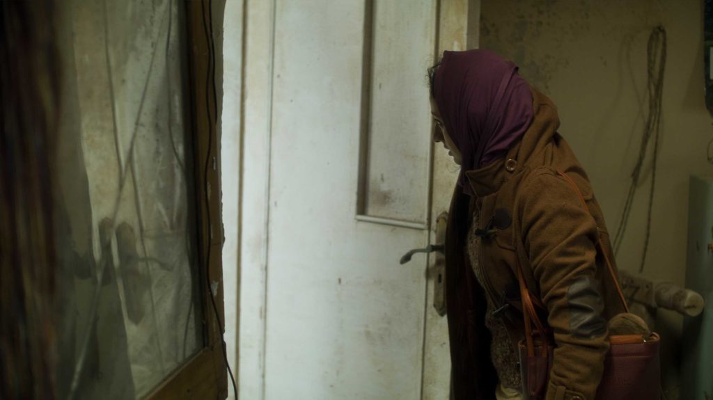 Woman opening run-down door