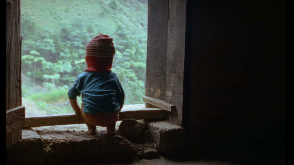 Small child sitting at window sill Vietnam