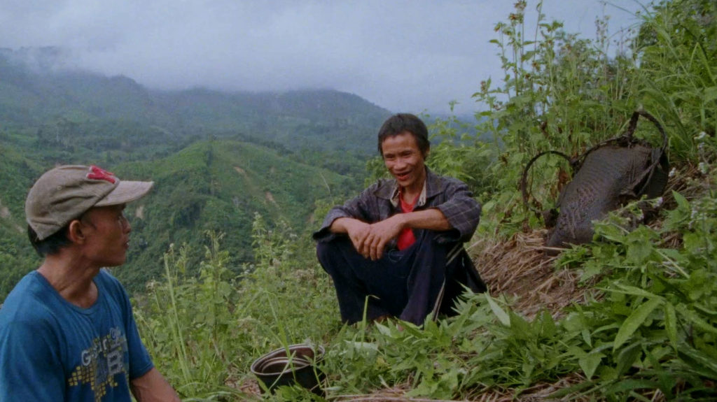 Men sitting in the hills of Vietnam